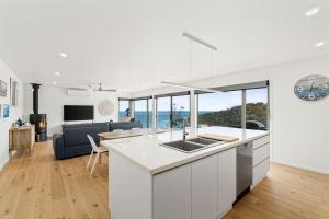 a kitchen and living room with a view of the ocean at Gums & Ocean Hideaway at Wye in Wye River +11 photos