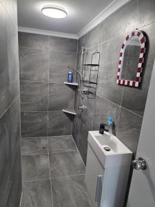a bathroom with a toilet and a sink and a shower at Sansa Farmhouse in Kelmscott