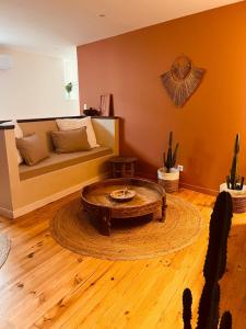 a living room with a couch and a coffee table at Maison Laroque & Spa in Bellefont-La Rauze