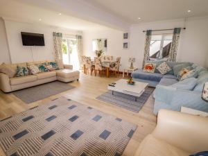a living room with a couch and a table at Charlecote House in Saundersfoot