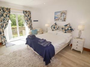 a bedroom with a large bed and a window at Charlecote House in Saundersfoot