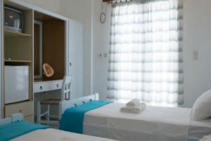 Postel nebo postele na pokoji v ubytování Hotel Faros