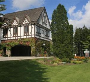 a large house with a green lawn in front of it at Peek'n Peak Resort Trademark Collection by Wyndham in Clymer