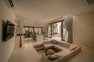 a living room with a couch and a table at Suasana by AYA in Uluwatu