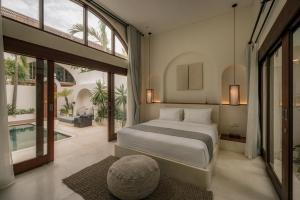 a bedroom with a bed and a swimming pool at Suasana by AYA in Uluwatu +73 photos