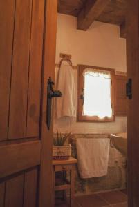 a bathroom with a sink and a window and a towel at La Lagunilla in Laguna del Marquesado +11 photos
