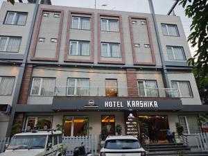 a hotel karachi with a car parked in front of it at Hotel Kaashika in Varanasi