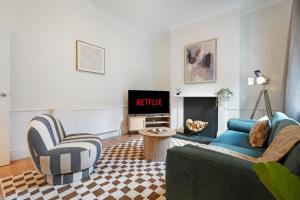 a living room with a couch and chairs and a television at Charming 4BR Retreat in Hull Sleeps 8 by Stay With Us in Hull