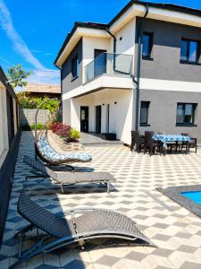 a patio with chairs and tables and a building at Grey House in Bucharest