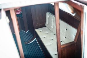 an overhead view of a white seat on a boat at Jahta Engures ostā in Engure +3 photos
