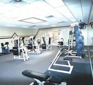 a gym with several tread machines in a room at Peek'n Peak Resort Trademark Collection by Wyndham in Clymer
