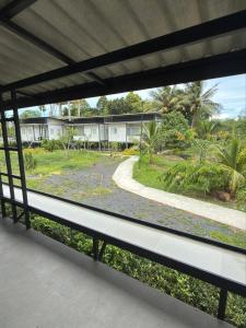 a view of a park through a window at Malina Guesthouse in Ko Phangan
