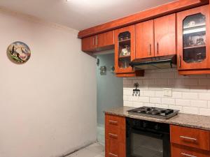 a kitchen with wooden cabinets and a stove top oven at Local Roots in Pinetown +16 photos