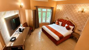a hotel room with a bed and a television at Ray of Maya near to taj mahal in Agra