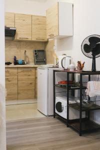 a kitchen with a white refrigerator and a dishwasher at Studio apartman NN - Boračko jezero in Konjic