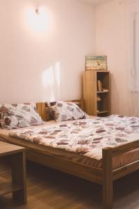 a large bed in a room with at Studio apartman NN - Boračko jezero in Konjic
