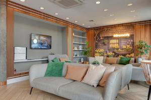 a living room with a couch and a tv at GRANO LIFE Gdańsk in Gdańsk +141 photos
