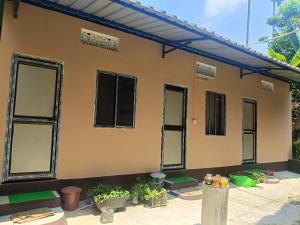 a house with windows and plants in front of it at Pranoti guest house in Dibrugarh