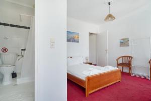 a bedroom with a bed and a toilet in a room at Xenia & Antonis in Nikiana +167 photos