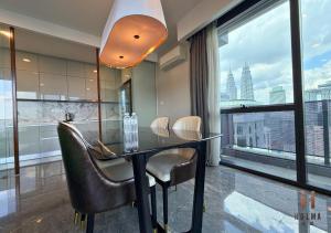 a dining room with a table and chairs and a large window at The Platinum 2 Kuala Lumpur by HOLMA in Kuala Lumpur