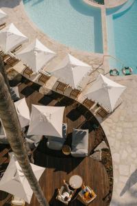 an overhead view of a pool with white umbrellas at President Hotel in Cape Town