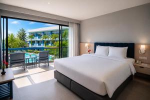 a bedroom with a large white bed and a balcony at Phuket Island View Resort in Karon Beach +74 photos