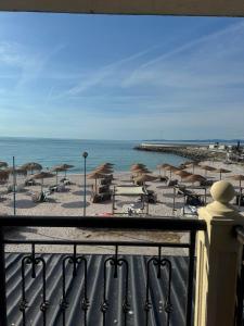 a view of a beach with umbrellas and the ocean at Студиа При Американеца in Pomorie