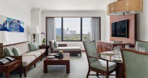 a living room with a couch and a table at The Peninsula Manila in Manila