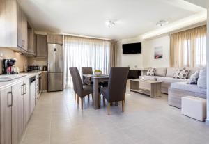 a kitchen and living room with a table and a couch at Villa Lefkopetra in Triopetra
