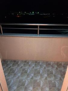 a balcony with a view of the city at night at Apartmani Katarina in Donje Čičevo