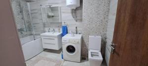 a bathroom with a washing machine and a washer at Apartmani Katarina in Donje Čičevo +21 photos