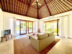 a living room with a couch and a table at Peninsula Bay Resort in Nusa Dua