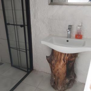 a bathroom with a sink made out of a tree stump at Hotel Buse in Alaçatı