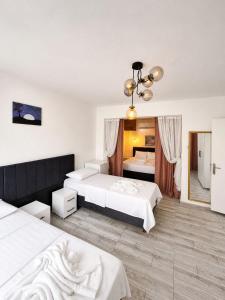a hotel room with two beds and a bedroom at Hotel Buse in Alaçatı