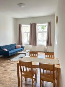 a living room with a couch and a table and chairs at Dům na náměstí in Nová Bystřice