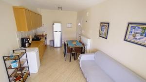 a kitchen with a couch and a table and a refrigerator at Teos in Metamorfosi