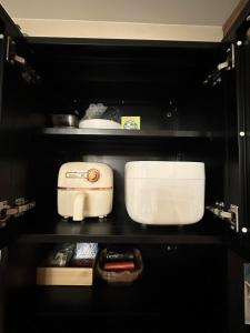 a kitchen with a toaster and other appliances on shelves at JB's Space in Cagayan de Oro