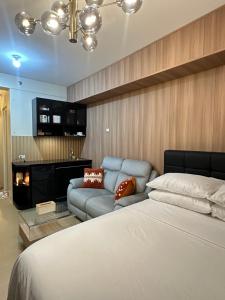 a bedroom with a bed and a couch at JB's Space in Cagayan de Oro