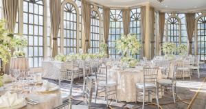 a room with tables and chairs in a room with windows at The Peninsula Manila in Manila +49 photos