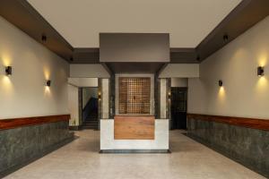 a hallway with a wooden door in a building at Hotel Raha Tower in Dar es Salaam