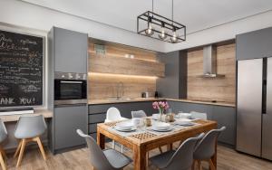 a kitchen with a table and chairs and a chalkboard at Olive Tree House in Anavyssos