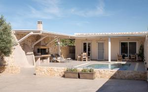 a house with a swimming pool and a patio at Olive Tree House in Anavyssos +28 photos