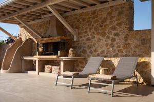 two chairs sitting on a patio with a table at Olive Tree House in Anavyssos