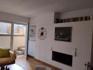 a living room with a fireplace and a couch at Studio47 in Athens