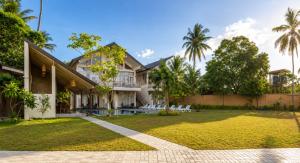 an exterior view of a house with a yard at The Oceans Edge in Dodanduwa