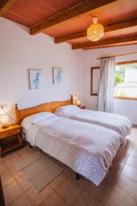 a bedroom with two beds and a window at Son Flor Agroturisme in Santa Margalida +145 photos