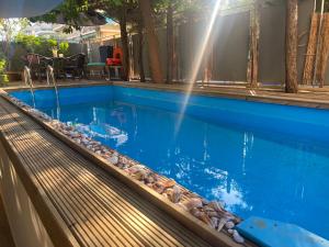 a swimming pool with blue water and rocks around it at Studio47 in Athens