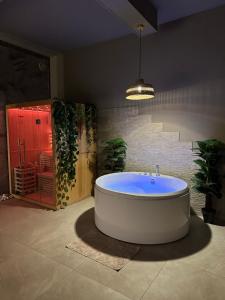 a large bathroom with a large tub in a room at BREATH47SPA - Private Spa Suite White Jacuzzi & Sauna in Marbella in Marbella +14 photos