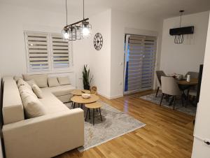 a living room with a couch and a table at Apartman ANATEO Istocno Sarajevo in Vranješ