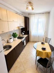 a kitchen with a table and a dining room at Ama Residence 1 in Deva